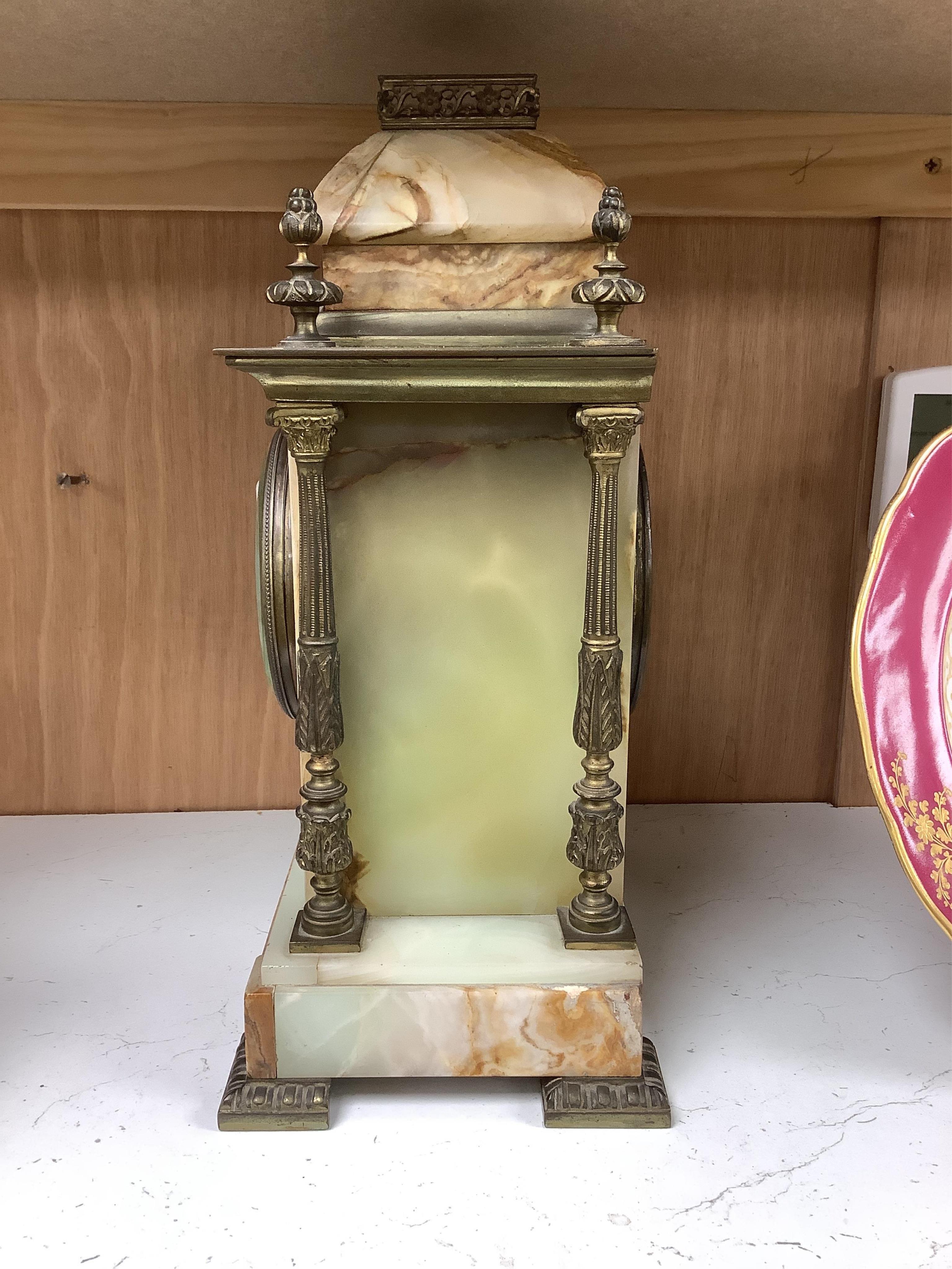 An early 20th century marble and onyx mantel clock with enamel dial with pendulum, no key, 32cm high. Condition - fair, untested